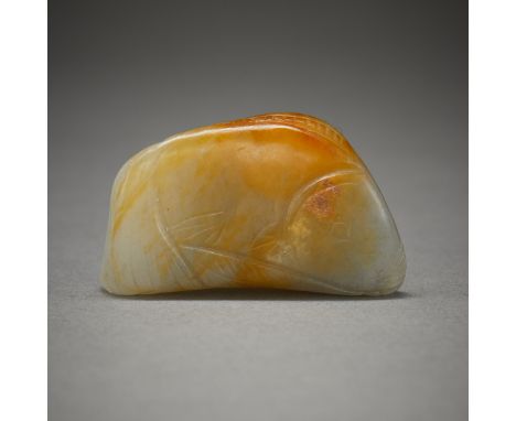 Chinese carved jade fish. Triangular form carved of a blue-green jade with russet inclusions.Height: 1 in x width: 1 1/2 in x