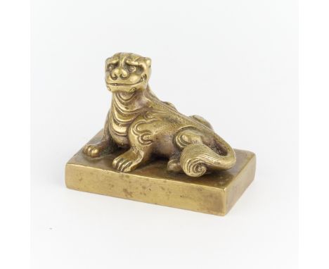 Chinese bronze seal depicting a foo dog resting atop the base of the stamp, Qing dynasty.Height: 2 in x width: 2 1/2 in x dep