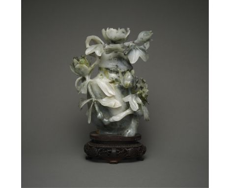 Chinese jadeite vase with carved floral forms and broad clusters of verdant green inclusions running diagonally throughout th