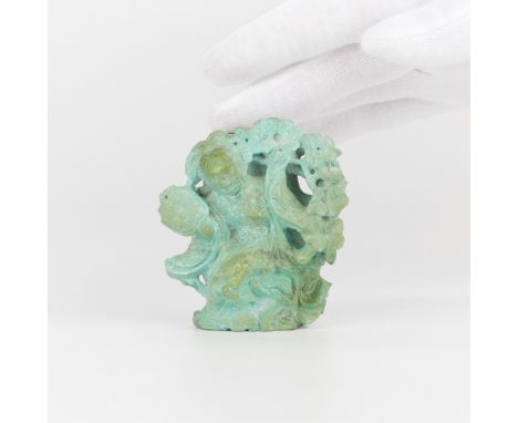 Small Chinese turquoise vase carved in the form of a Guanyin waving a fan and swaying to her side amid flowers. Carved symbol