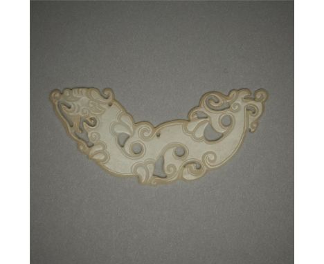 Chinese carved jade huang plaque in the form of a dragon. Of a pale jade coloration with finely incised lines and a drilled h