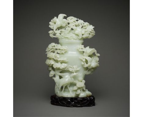 Large and beautifully designed Chinese jade or hardstone vase with cover. Carved of a delicately green stone, including depic