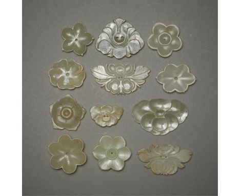 Group of 12 Chinese carved jade buttons in the form of flowers.Height ranges from 1/2 in to 1 1/4 in; width ranges from 1 in 