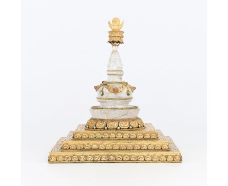 Chinese Buddhist rock crystal stupa with gilt copper base and applied decoration, late Qing dynasty. With etched and applied 