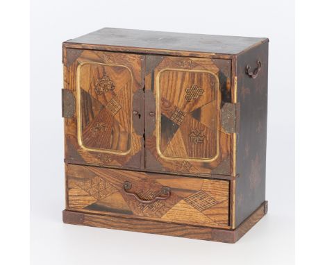 Japanese wooden cabinet with inlay portraying leaf-like forms and geometric marquetry throughout the surface, particularly al