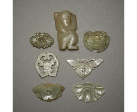 Group of seven Chinese jade carvings including:One somewhat opaque and pale off-white jade button of floral form.One carving 