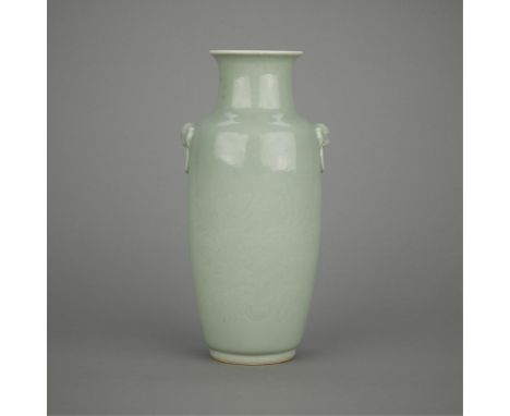 Chinese Qing porcelain vase with a celadon glaze and incised floral decoration. With two applied mask-form handles. Drilled, 