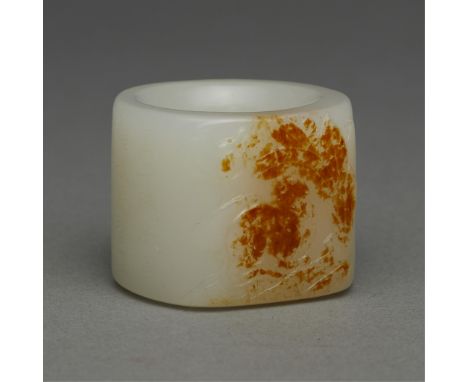 Chinese carved jade archer's ring. Skillfully carved along a russet inclusion to depict a cat and foliage. Characters carved 
