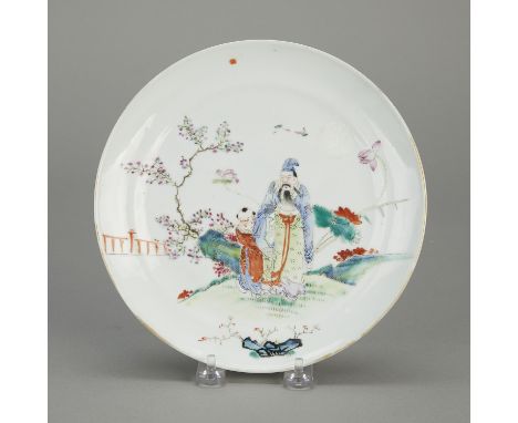 Chinese famille rose porcelain plate depicting a scholar and attendant in a garden, ca. late 19th - early 20th century.Diamet