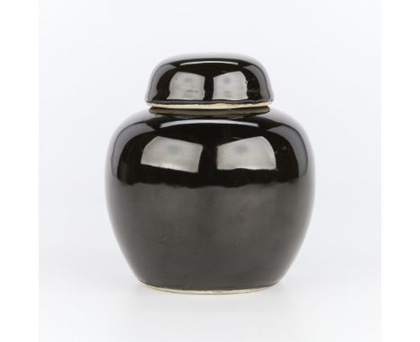 Chinese ceramic ginger jar, Kangxi era. Glazed in a thick, black reflective glaze. A white glazed underside and unglazed foot
