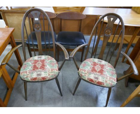 A pair of Ercol Golden Dawn elm and beech swan back Quaker elbow chairs 