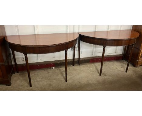 A pair of George IV mahogany demi-lune console tables 
