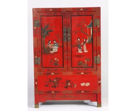 Chinese red lacquered side cupboard, 20th century, painted with figures within a garden setting, the pair of doors enclosing 