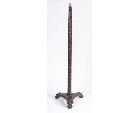 Chinese carved hardwood standard lamp, the tapering column carved with flower heads, raised on trifoil base, 154cm tall