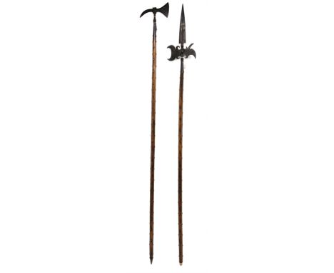 Large continental steel halberd axe the engraved blade with cast sunburst centre and long studded ash handle L219cm; and anot