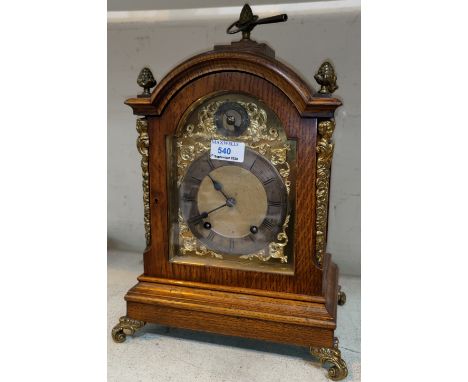 A Georgian style bracket clock in oak case with ornate brass mounts, brass dial and ting tang striking movement, height 42 cm