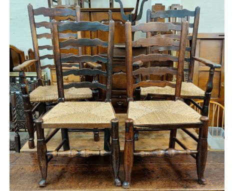 A near matching set of 8 (6+2) 19th Century countrymade elm ladder back dining chairs with rush seats and turned legs