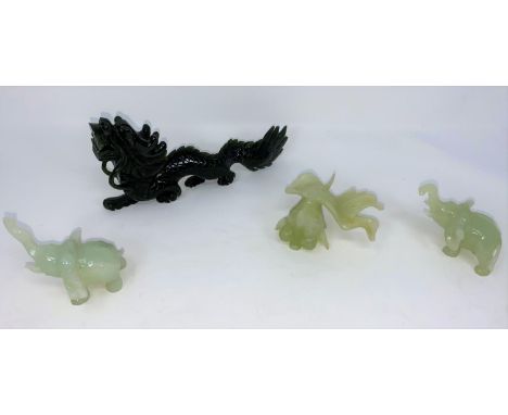 A medium Chinese 'spinach green' hardstone dragon and four other miniature jade coloured piecesCouple of chips to fish (!) ot