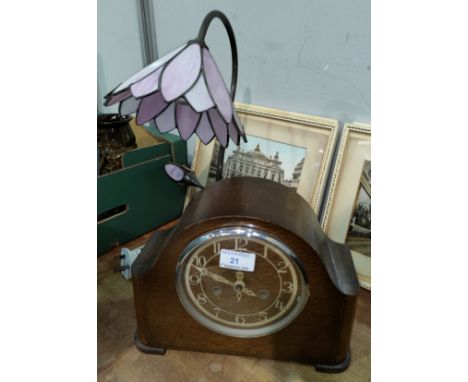 A 1930's striking mantel clock in oak case; a Tiffany style table lamp; a collection of OS maps 