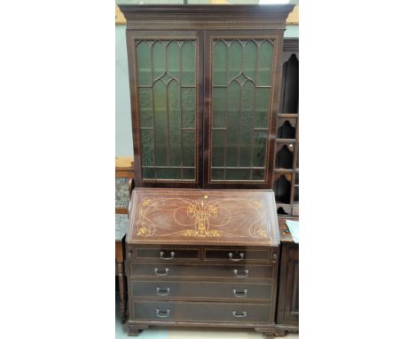 An Edwardian mahogany bureau/bookcase with extensive ebony and boxwood line inlay, the upper section having moulded and denti