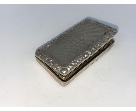 A large Georgian rectangular engine turned vinaigrette with embossed floral border, gilded interior with hinged pierced grill