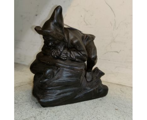 A 19th century cast iron novelty tobacco jar, bearded dwarf leaning on a rock looking at a snail, height 13 cm; a reproductio