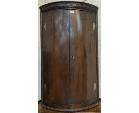 An 18th century oak panelled bow front corner cupboard height 113cm 