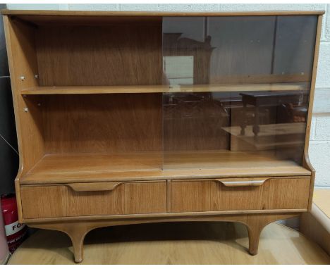 A mid 20th century teak sliding door bookcase with two drawers bellow 