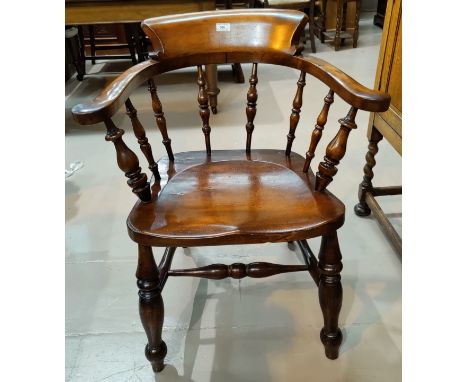An early 20th century smokers bow armchair 
