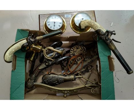 A collection of reproduction pistols and guns; a reproduction ship's clock/barometer; brassware; etc. 