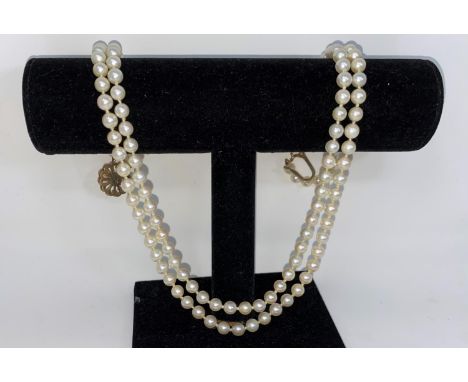 A cultured pearl double strand necklace  with 9 carat clasp set pearl and rubycame with a Mikimoto box and certificate but do