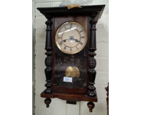 A small A Victorian style pine Vienna style wall clock in mahogany case, with striking movement 