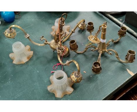 A three branch brass light fitting with glass shade and another five branch brass ceiling light