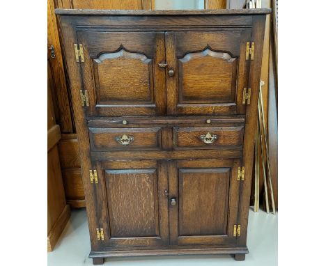 An oak Titchmarsh and Goodwin oak side cabinet with double cupboard above and bellow two drawers and a pull out shelf (label 