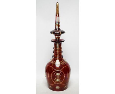 An early 20th century Bohemian overlaid and painted ruby glass decanter, 51cm. Condition - fair Six of the yellow glass nippl