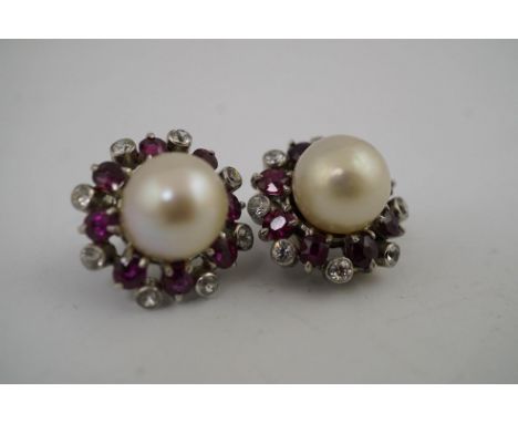 A pair of pearl earrings, with ruby and diamond surrounds, unmarked, 8.2 g gross. Condition - fair