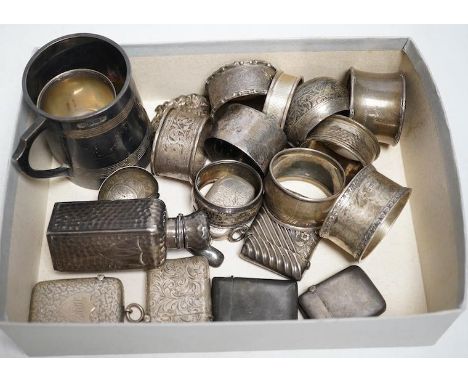 A group of small silver to include a christening mug, 143g, an egg cup, ten various napkin rings, 184g, a spot hammered bottl