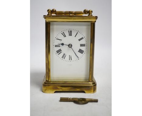 An early 20th century brass repeating carriage clock with key, 13cm. Condition - fair to good, not tested as working