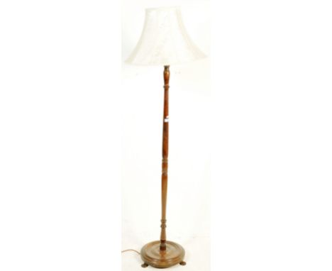 A mid 20th century circa 1940’s standard lamp. The lamp having a wooden turned column raised on a circular base with hairy pa