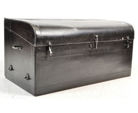 A vintage 20th century black leatherette trunk from a classic car having a curved lid opening to reveal a spacious interior. 