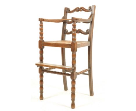 A 19th century Victorian children's high chair having a scrolled back rest cane seat, straight elbow rests, foot rest below r