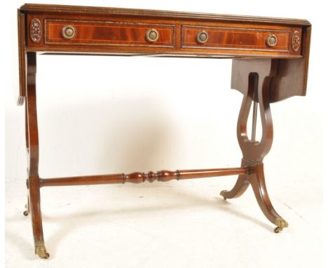 A 20th Century Regency revival&nbsp; mahogany inlaid sofa table / drop sided writing desk having twin drawers with ring handl