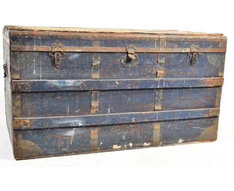 An early 20th century circa 1920’s large wooden shipping trunk. The trunk having a hinged lid with metal banded to the corner
