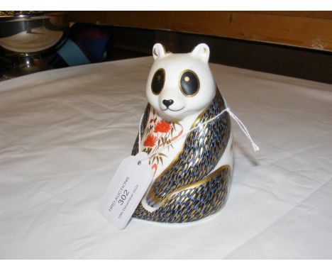 A Royal Crown Derby paperweight in the form of a panda