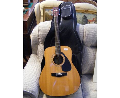 A Yamaha FG-401 six string acoustic guitar with soft carrying case