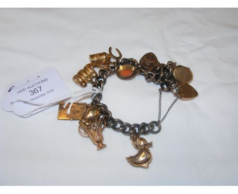 A charm bracelet (some charms gold)