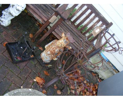 A wrought iron plant stand, boot scraper, together with cast metal pig ornament