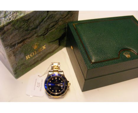 A gents Rolex bi-metal Submariner 1989 wrist watch, model number 16803 - with box, papers and spare links