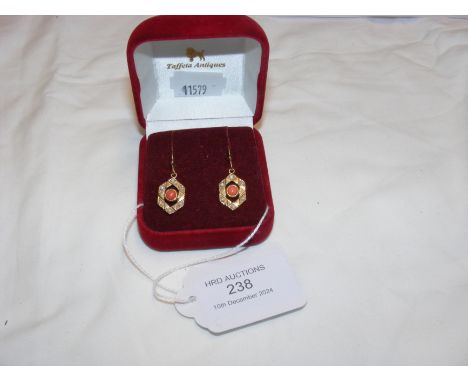 A pair of coral and pearl drop earrings in gold surround