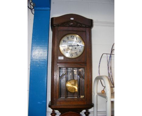 An oak cased wall clock 